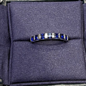 Navy sandal with a brand logo on a gray surface