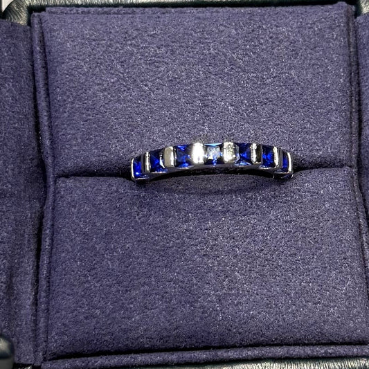 Navy sandal with a brand logo on a gray surface