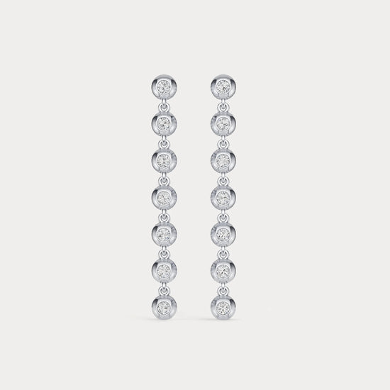 Pair of diamond earrings on a light gray background