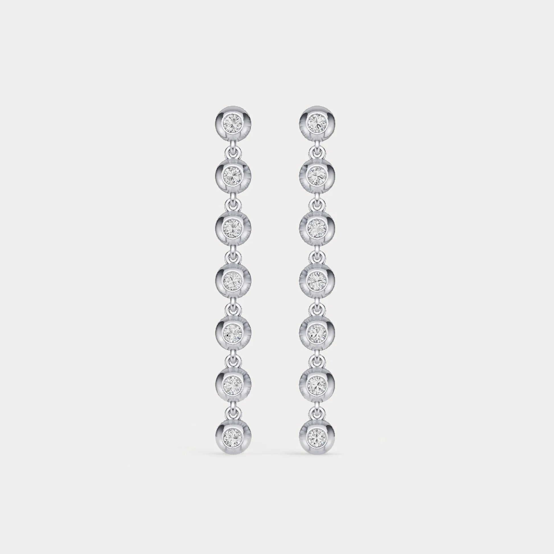 Pair of diamond earrings on a light gray background