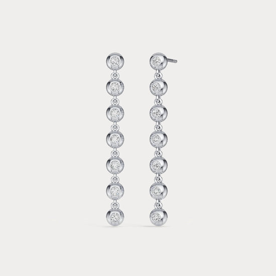 Pair of diamond earrings on a light gray background