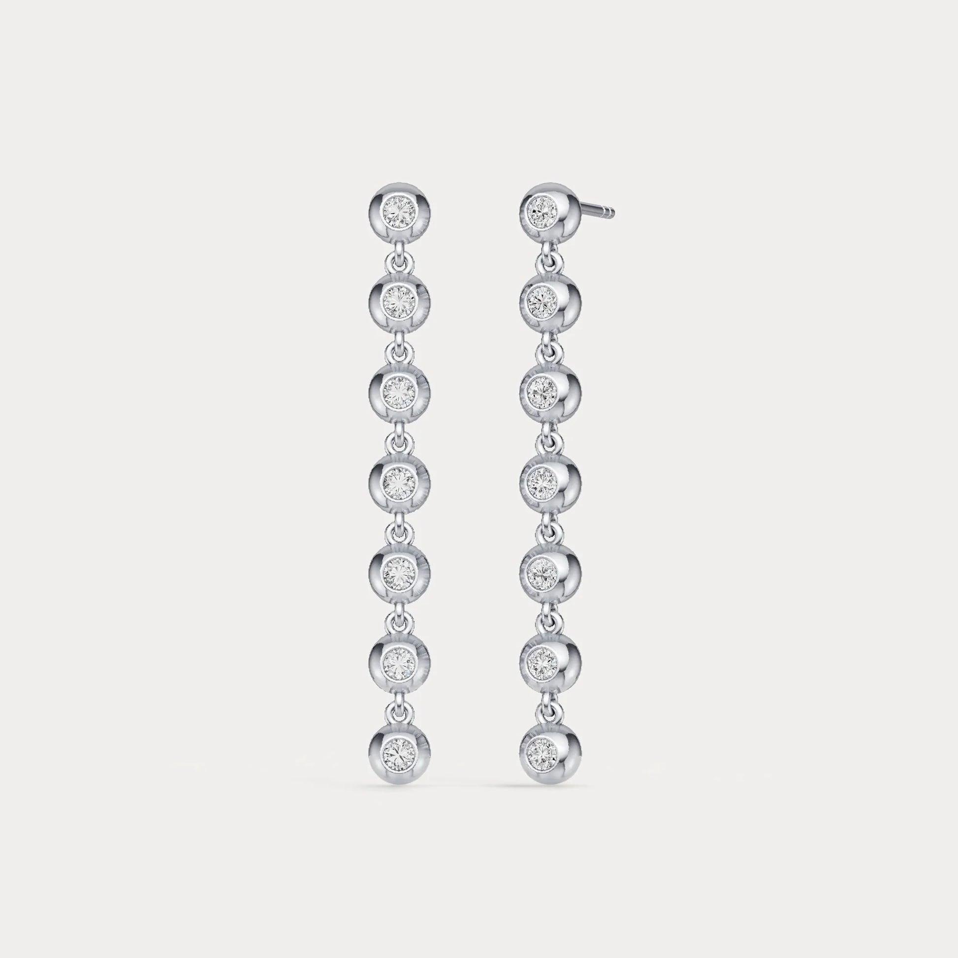 Pair of diamond earrings on a light gray background