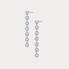 Pair of silver drop earrings on a light gray background