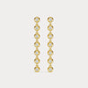 Gold earrings with clear stones on a light gray background