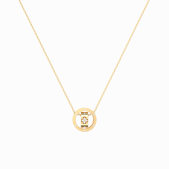 Gold necklace with a round pendant on a black background
