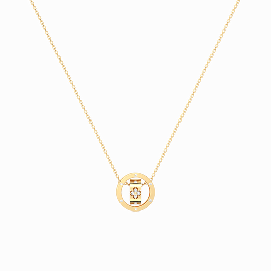 Gold necklace with a round pendant on a black background