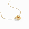 Gold necklace with a heart-shaped pendant on a white background