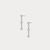 Pair of silver earrings with clear stones on a light gray background