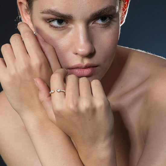 Woman wearing a silver ring with a blue background