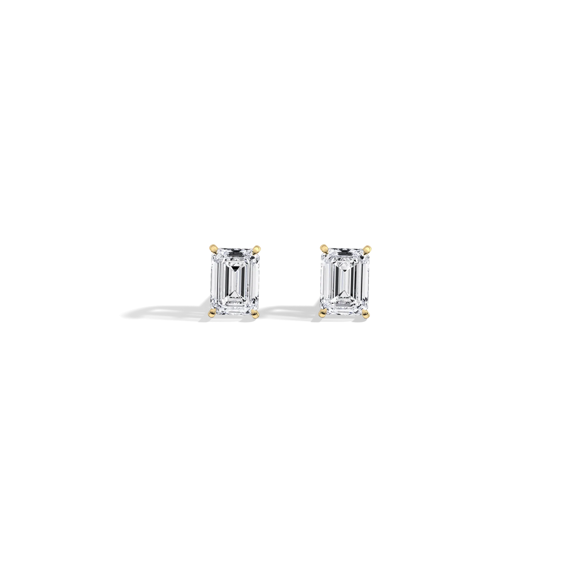 Pair of emerald-cut diamond earrings on a white background