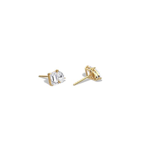 Gold earrings with clear gemstones on a white background