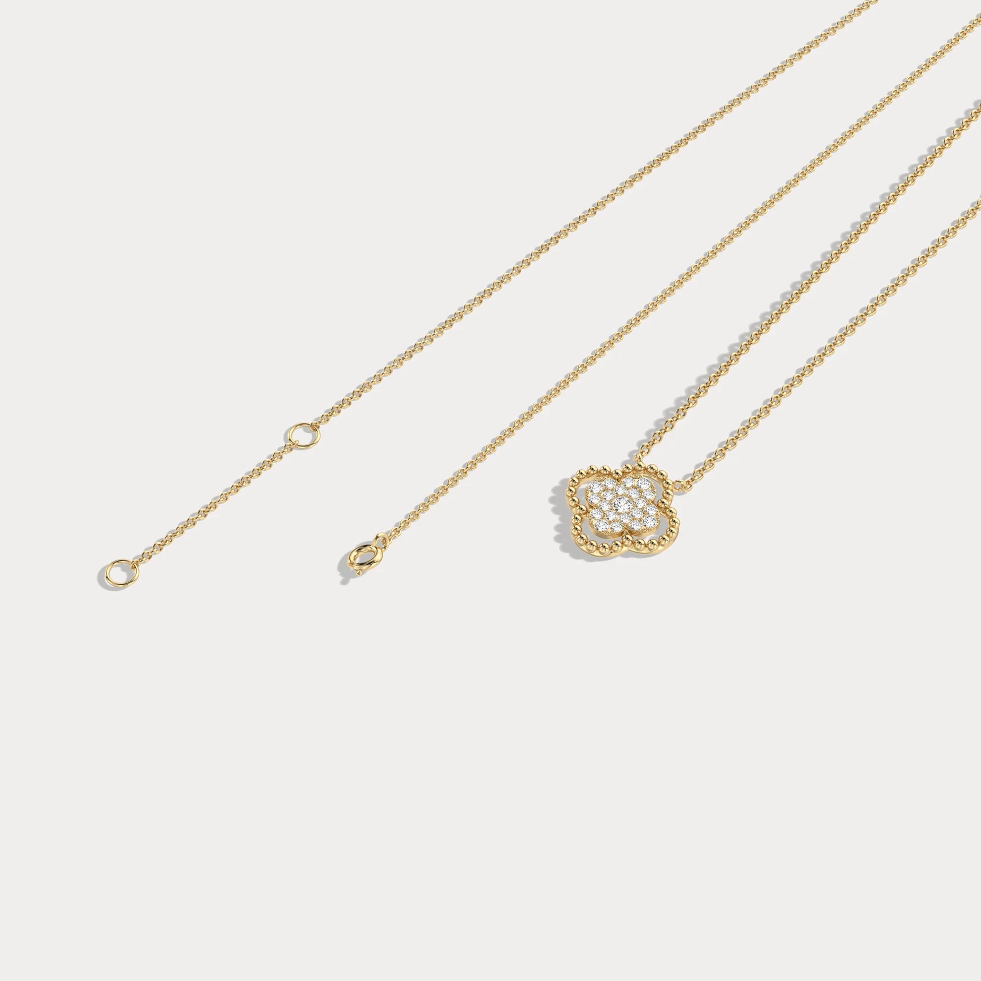 Gold necklace with a floral pendant on a light gray background