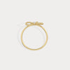 Gold bracelet on a light gray background