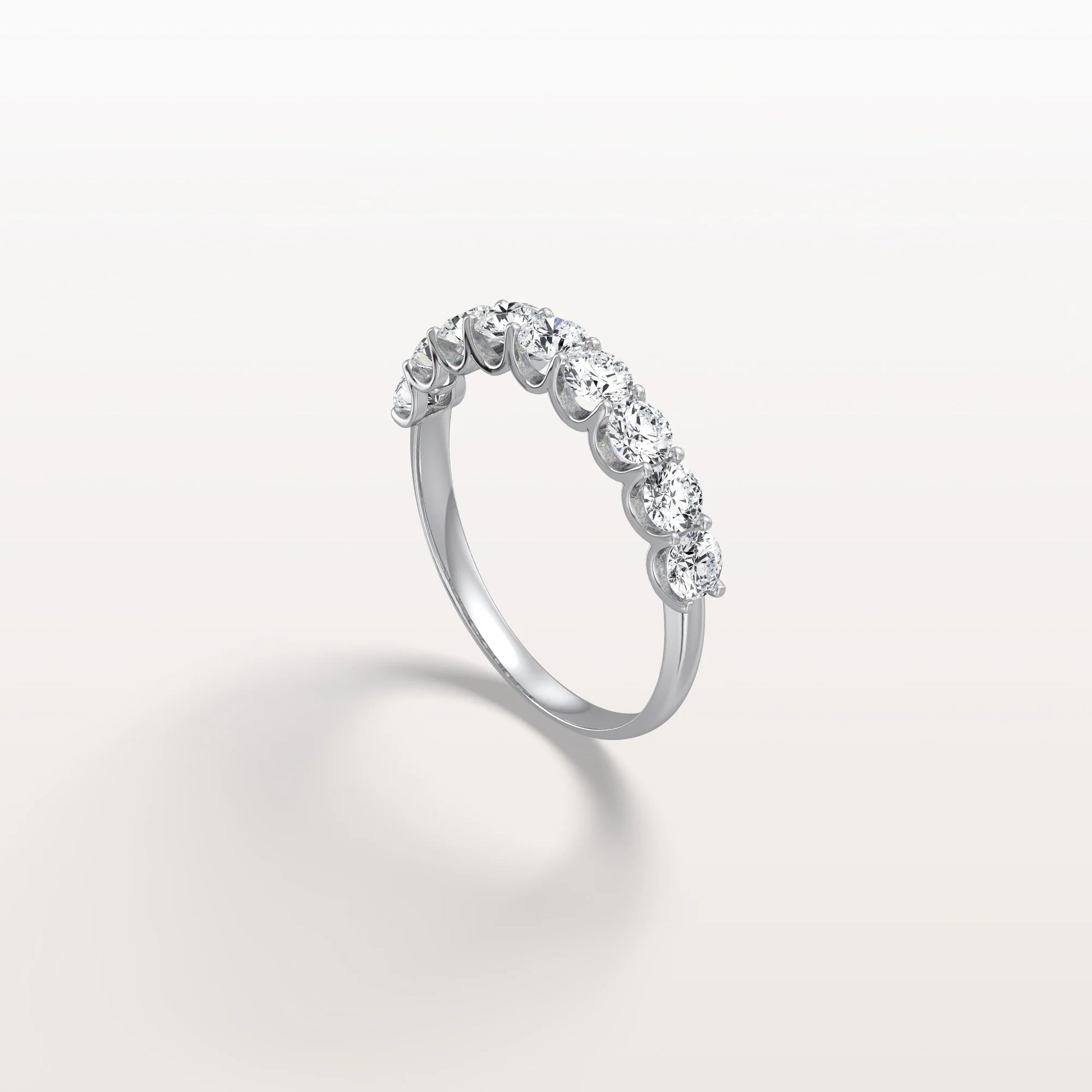 Silver ring with diamonds on a light gray background
