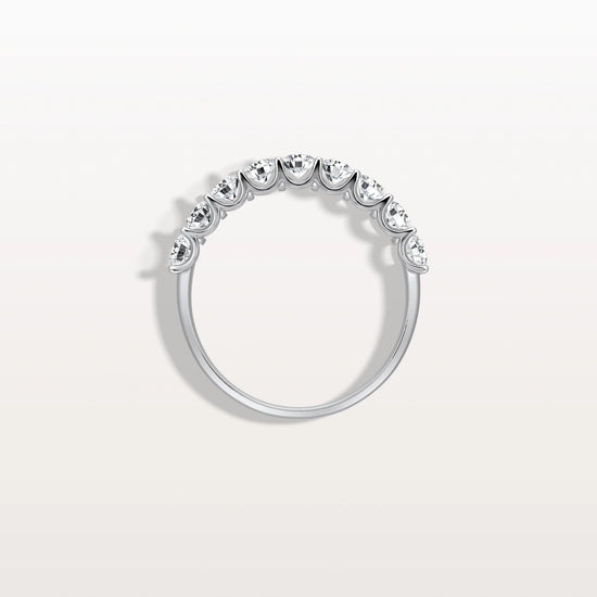 Silver ring with small diamonds on a light gray background
