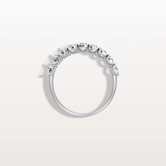 Silver ring with small diamonds on a light gray background