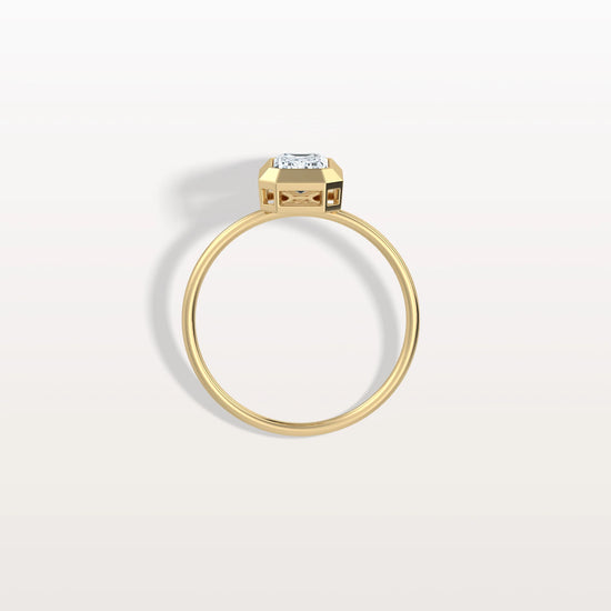 Gold ring with a diamond on a light gray background