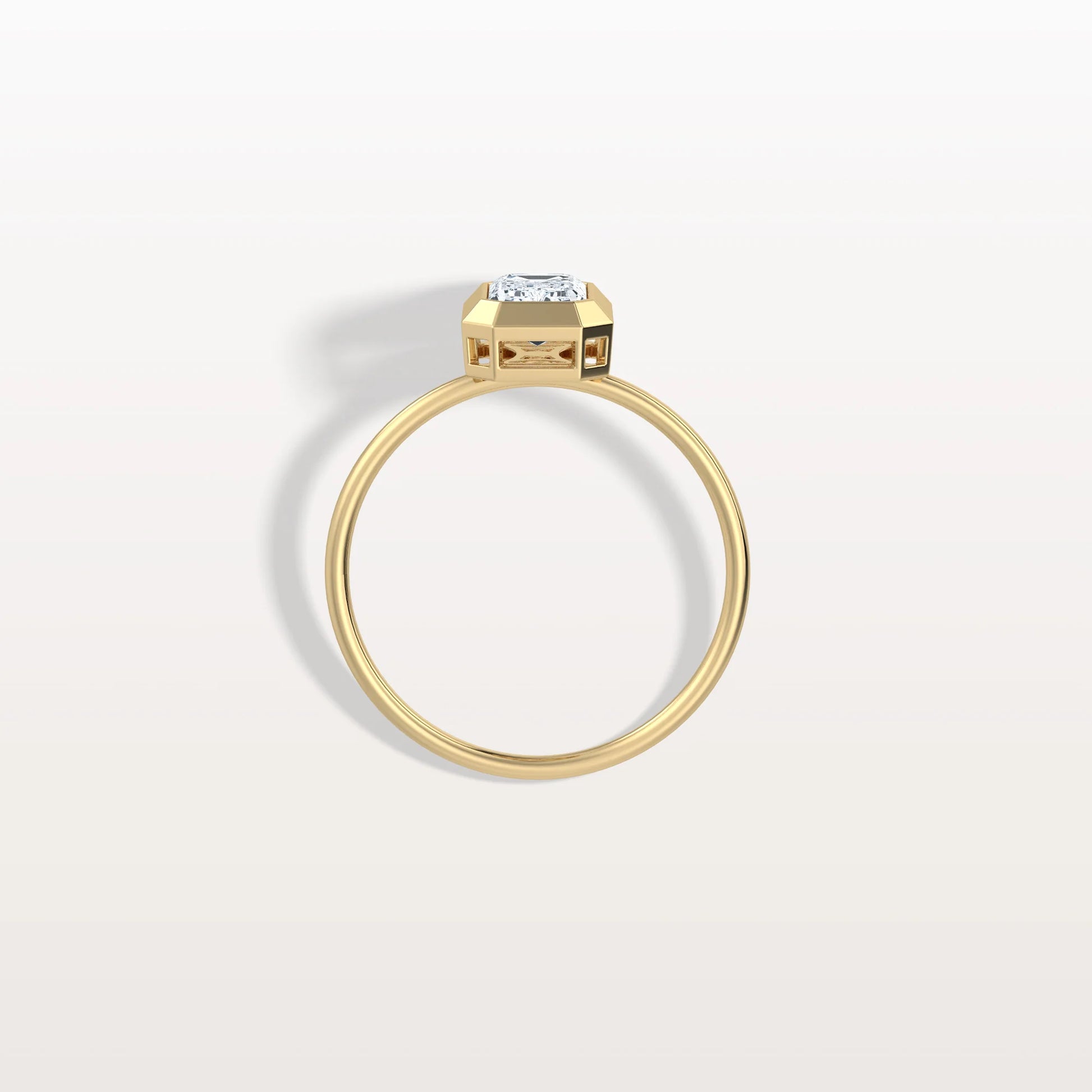 Gold ring with a diamond on a light gray background