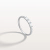 Diamond ring with baguette and round cut diamonds on a light gray background