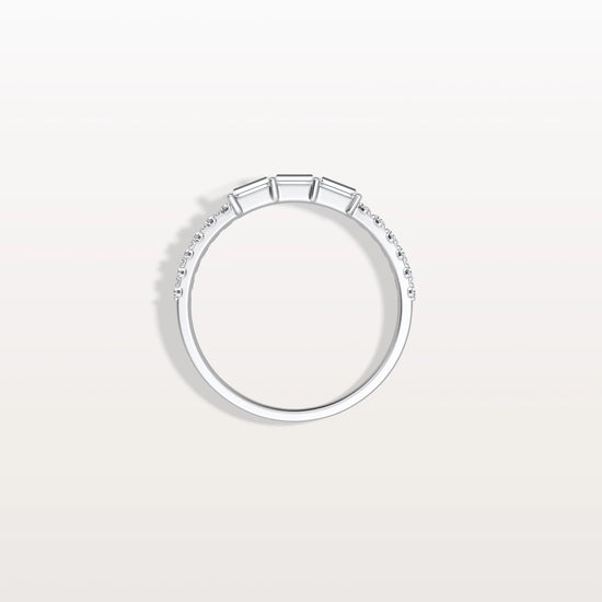 Silver ring with small diamonds on a light gray background