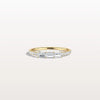 Gold ring with diamonds on a light gray background