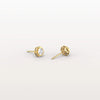 Gold stud earrings with clear gemstones on a light gray background