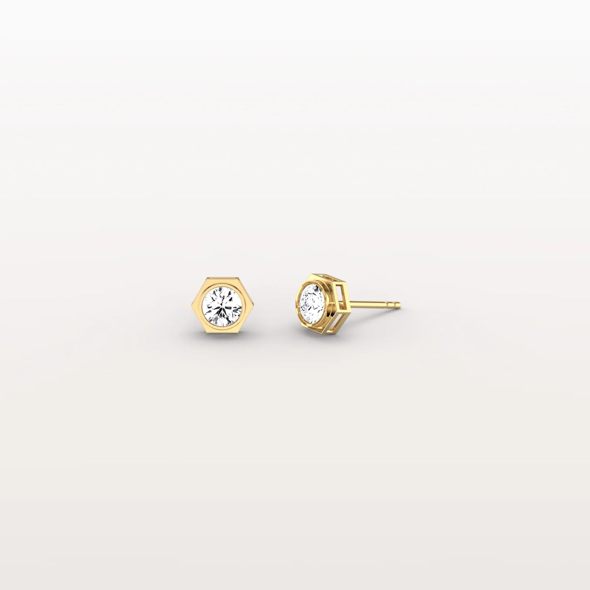 Gold stud earrings with gemstones on a light gray background