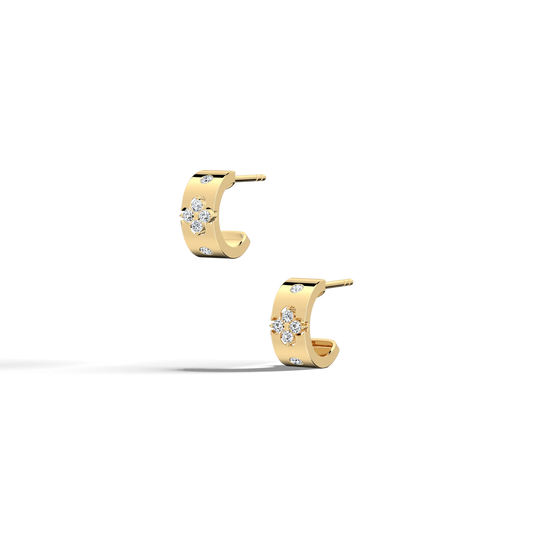 Gold hoop earrings with diamond accents on a white background