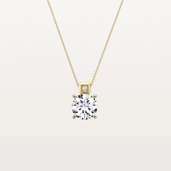 Gold necklace with a diamond pendant on a light beige background