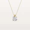 Gold necklace with a diamond pendant on a light beige background