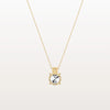Gold necklace with a round pendant on a light gray background
